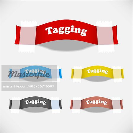 A set of colorful paper tags attached with sticky tape.