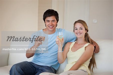 Couple drinking a glass of wine in their living room