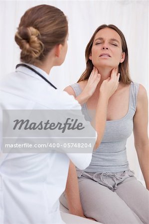 Doctor examining patients painful throat