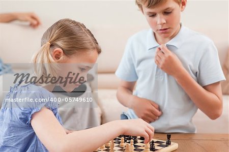 Children playing chess in a living room