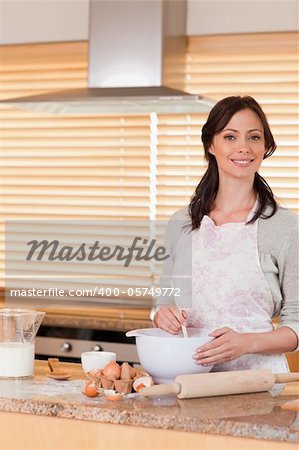 Portrait of a beautiful woman baking in her kitchen