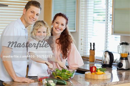 Family preparing salad together