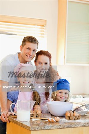 Happy smiling family with baking ingredients