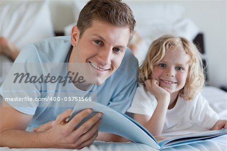 Father and son looking at magazine together