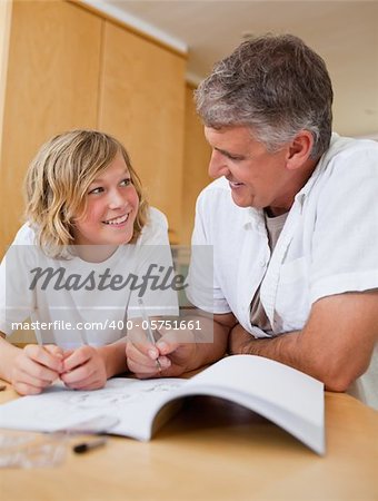 Male helping his son with homework