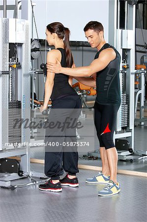 Sporty couple exercising at the fitness gym