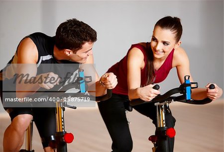 Sporty couple exercising at the fitness gym