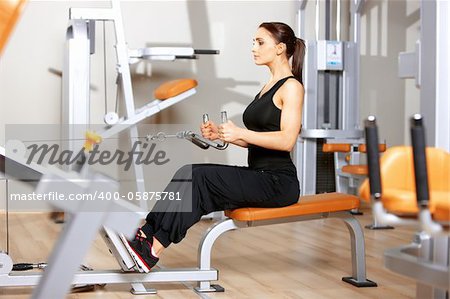 Beautiful woman exercising at the fitness gym