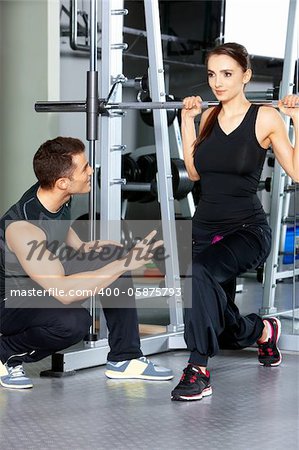 Sporty couple exercising at the fitness gym