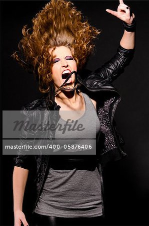ecstatic woman is dancing to the rock music