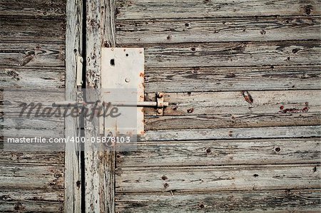 Old latch with padlock on doors