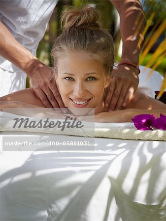 Young beautiful blonde caucasian woman gets massage and beauty treatment in luxury resort