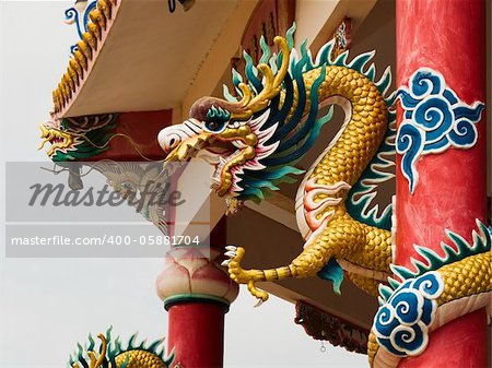 Right Golden dragon statue on red pillar in Chinese Temple style