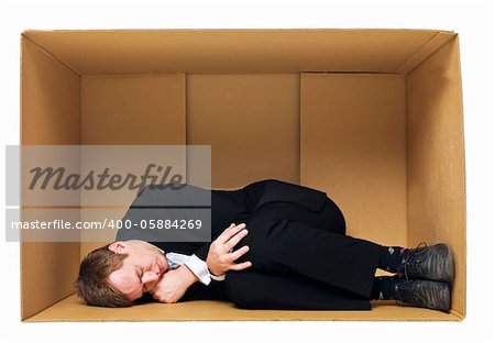 Sleeping in a cardboard box isolated on white background