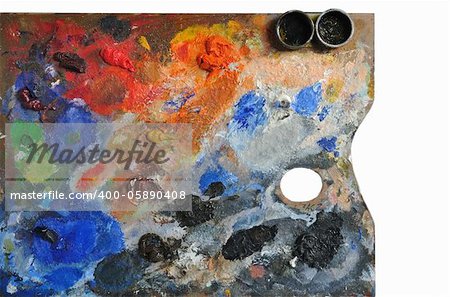 Artistic palette covered with colors on white background