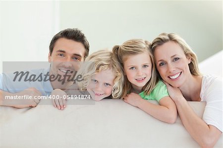 Smiling family together on the couch