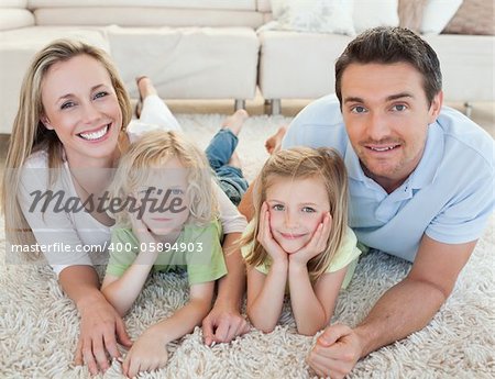 Family lying on the carpet together