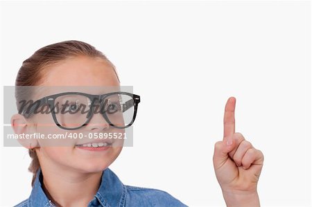 Girl pointing at something against a white background