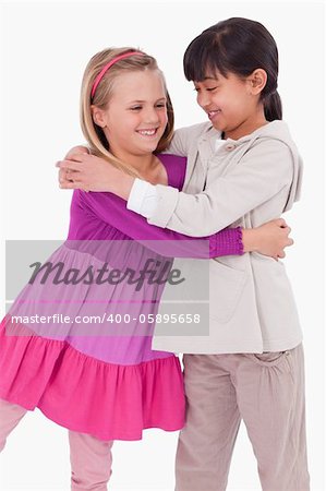 Portrait of girls hugging against a white background