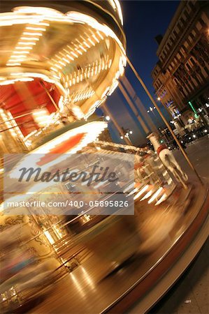 merry-go-round twisting fast in the night with thousands lights