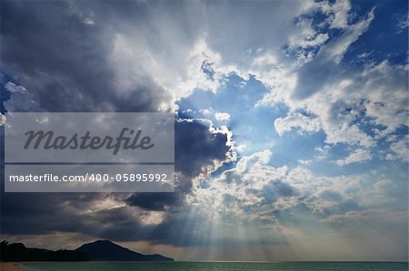 Cloudy sky over the sea with the sun - an evening landscape