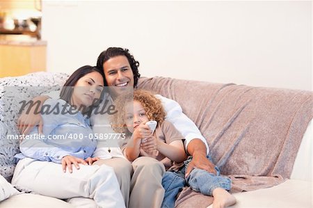 Young family watching television together