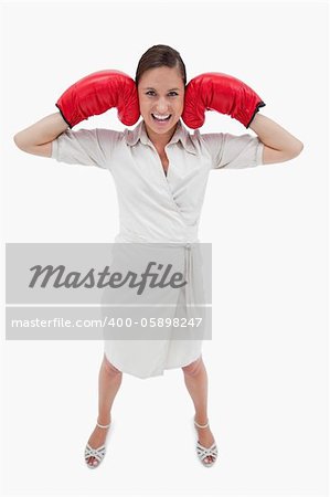 Portrait of a businesswoman with boxing gloves against a white background