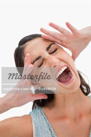 Portrait of a woman shouting against a white background