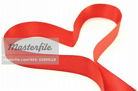 Beautiful heart from red satin ribbon on a white background