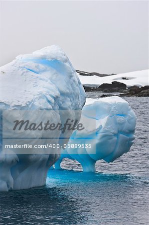 Huge iceberg in Antarctica, clear sky, azure water, sunny day