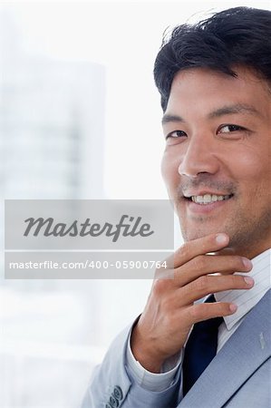 Portrait of a smiling office worker thinking while looking at the camera