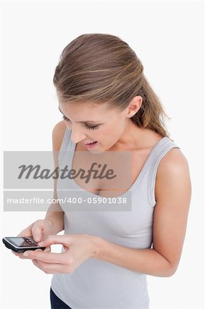 Portrait of a woman reading a text message against a white background