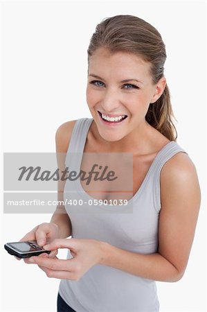 Portrait of a happy woman holding her mobile phone against a white background