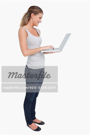 Portrait of a woman using a laptop against a white background