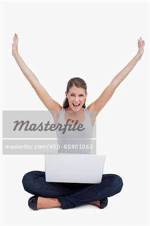 Cheerful woman using a notebook against a white background
