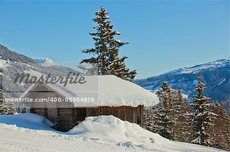 Alpine landscape. Snow-covered house, mountains. Tyrol, Austria