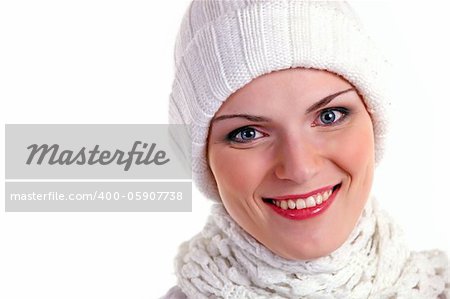 Closeup portrait of beautiful cheerful girl in winter cap over white background