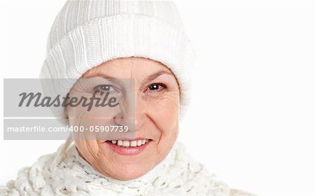 Smiling mature woman in winter cap isolated over white background