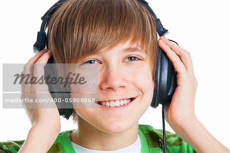 Close-up portrait of a male teenager listening to music with headphone. Isolated on white.