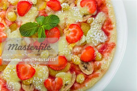 Appetizing fruit pizza on a white plate