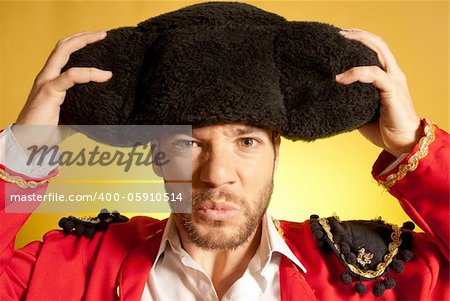 Bullfighter putting on big montera hat humor spanish colors