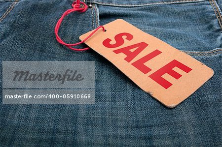 Closeup of Blue Jeans With Brown Sale Tag