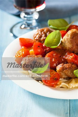 farfalle pastawith meatballs, cherry tomatoes and basil