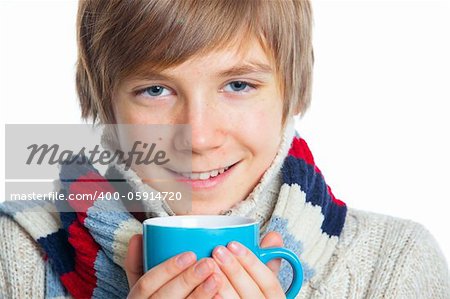 Portrait of young smiling cute frozen teenager in a scarf and with blue cup, isolated on white,