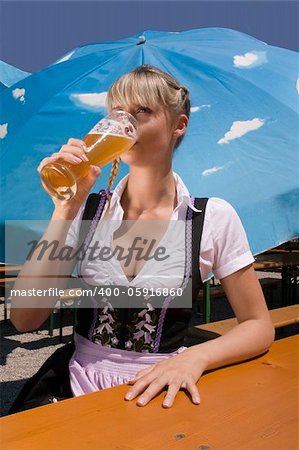 Young woman in traditional costume in the beer garden