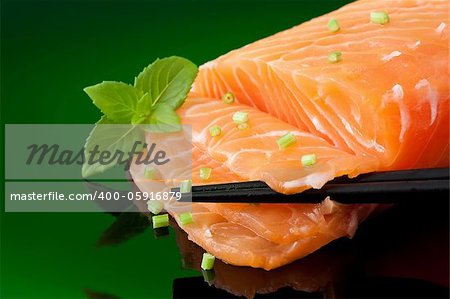 a slice of fresh salmon ready for sashimi