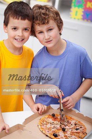 Hungry boys with pizza in their room