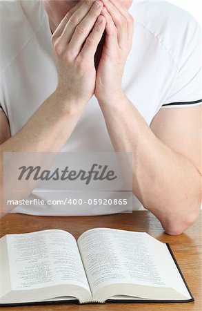 Man praying with the Bible