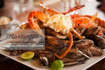 Dish with crab and mussels. Selective focus on the crab's body.