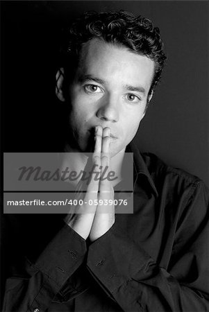 Handsome man portrait with hands on mouth black and white